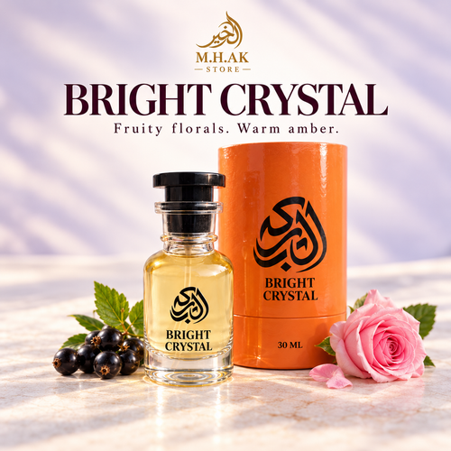 Al Barkah Bright Crystal 30ml perfume bottle beside its orange cylindrical packaging